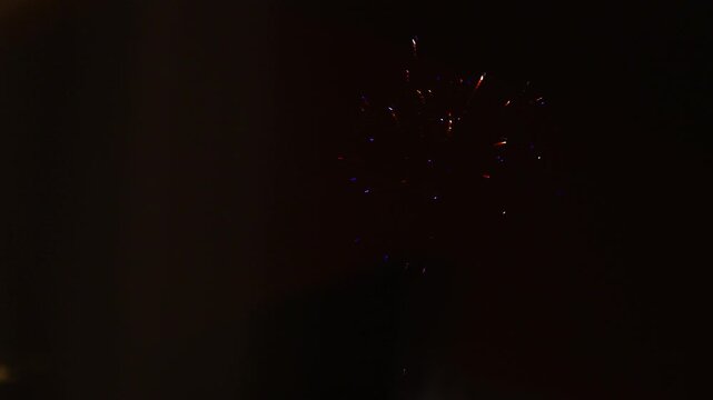 warm diwali fireworks reflect on window