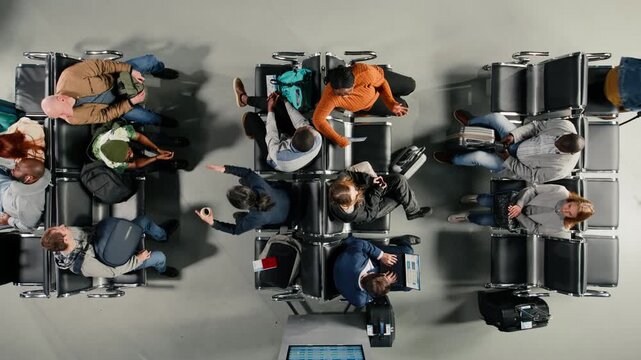 Checking visa documents, talking and people in airport hub, top down view. Checking plane tickets, devices and travelers having conversations during flight layover, high angle shot