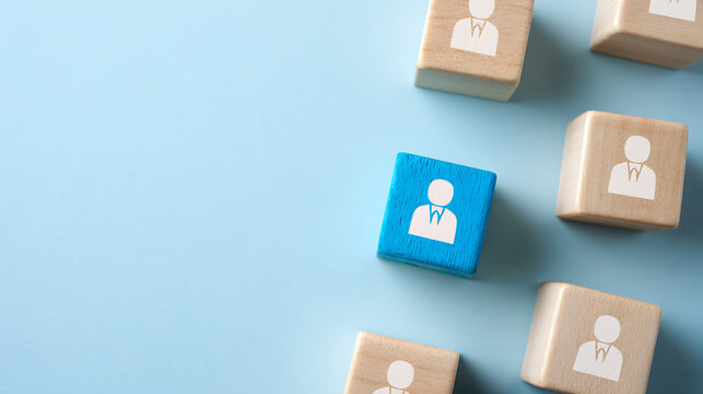 Unique individual stands out from the crowd, represented by a distinct blue block among several light wood blocks with person icons