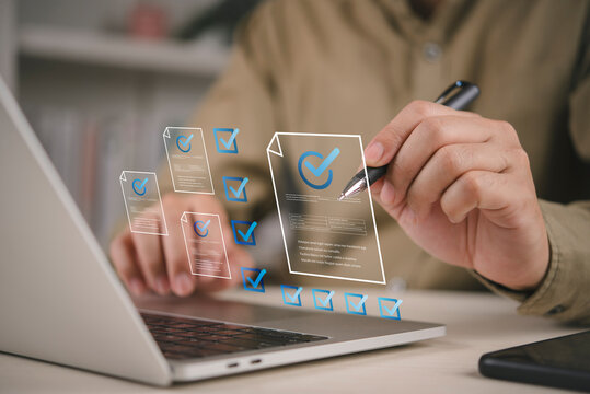 Quality assurance worker checking digital checklist hologram icon laptop screen ISO compliance verification standard assessment business process automation efficiency technology platform solution.