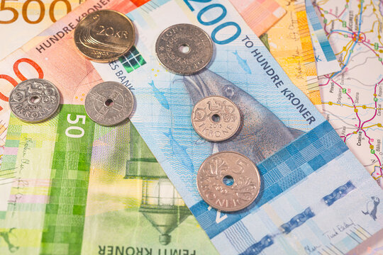 Scandinavian currency Swedish krona banknotes and coins on travel map representing economy and tourism.