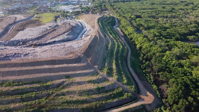 Aerial View of TPA Suwung Landfill with Terraced Earthwork and Surrounding Greenery