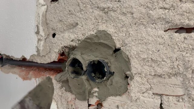 Wall construction repair. socket repair, large plpnom spatula and cement. Electrical wires wall. Wall socket hole. repair, replacement of sockets, electrical wiring. High quality 4k footage