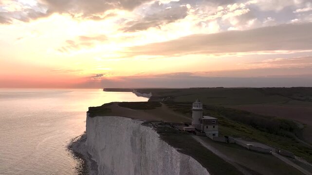Sunset over Belle Tout Lighthouse from a drone, English Channel, Beachy Head Cliffs, East Sussex, England