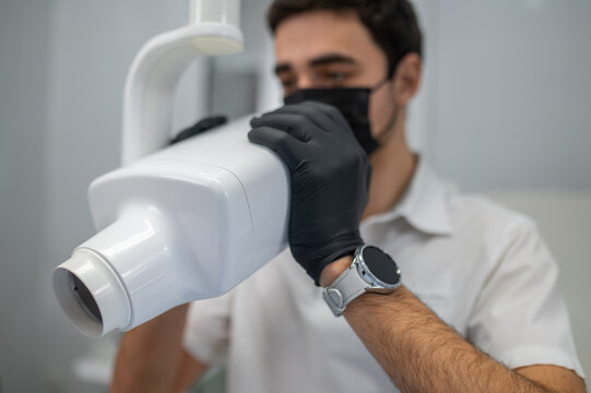 Dentist using dental x-ray machine