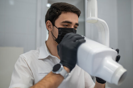Professional dentist performing oral x-ray