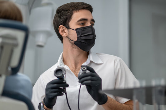 Dentist using intraoral camera for treatment