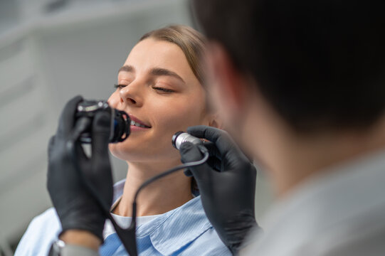 Stomatologist examining teeth with camera
