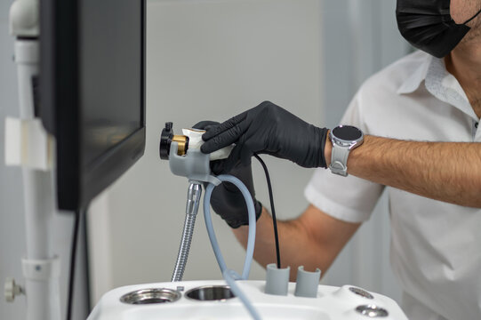 Medical specialist adjusting endoscopy camera unit