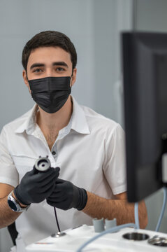 Medical professional adjusting endoscopy camera head
