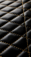 Fototapeta premium Macro view of black diamond quilted leather with yellow decorative stitching