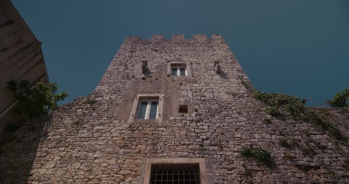 Stone tower facade with crenellations in Bale