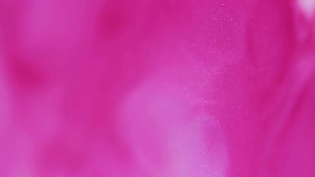 Vertical video. Marble splash. Shiny particles. Defocused pink color glitter water wet chemical paint floating on abstract art background.