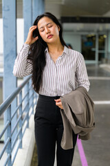 Fototapeta premium Asian woman walking, experiencing stress or headache