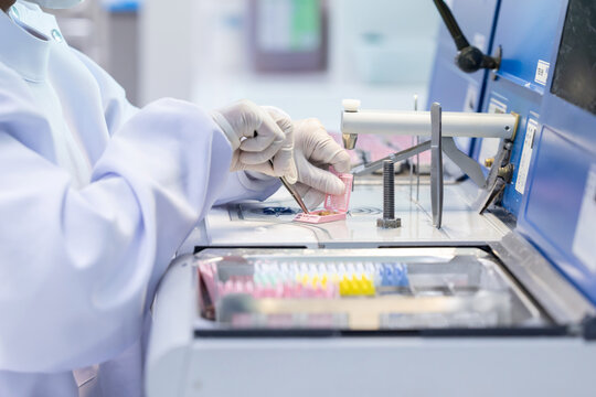 Laboratory technician conducting analysis with advanced equipment in a clean room environment during work hours
