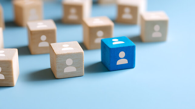 Unique blue wooden block stands out among many beige blocks, symbolizing individuality, leadership, and distinction on a light blue background