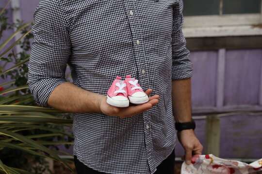 dad holding baby sneakers