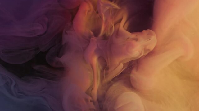 Fume haze. Explosion mist. Blur orange purple blue color ink cloud rainbow underwater texture smog splash on abstract warm background.