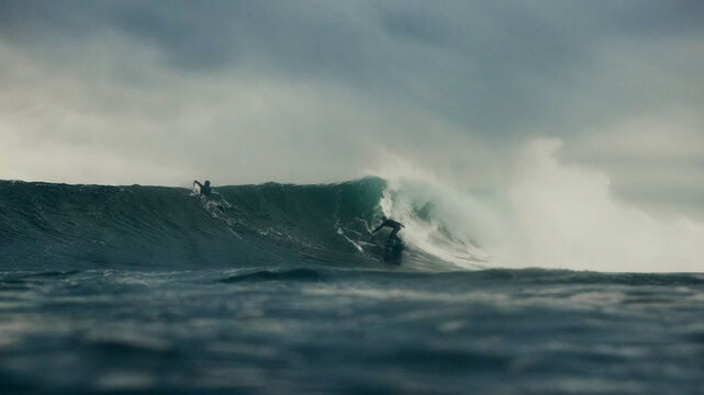surfers and storm over the sea