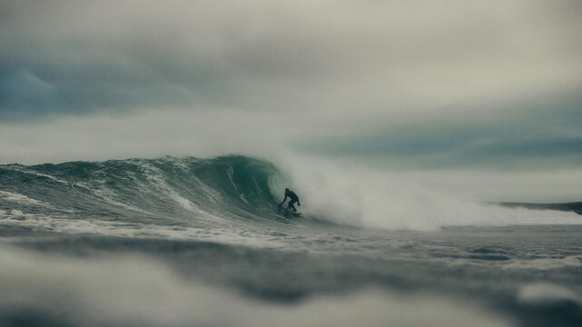 surfer and storm over the sea