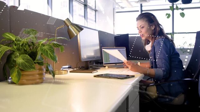 Business pro scanning report and comparing monitor, overlays linking paper to screens for checking