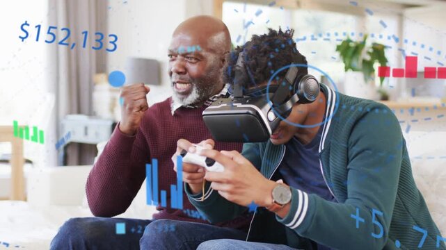 Younger man using VR headset and controller on sofa, older man cheering, AR gaming charts appearing