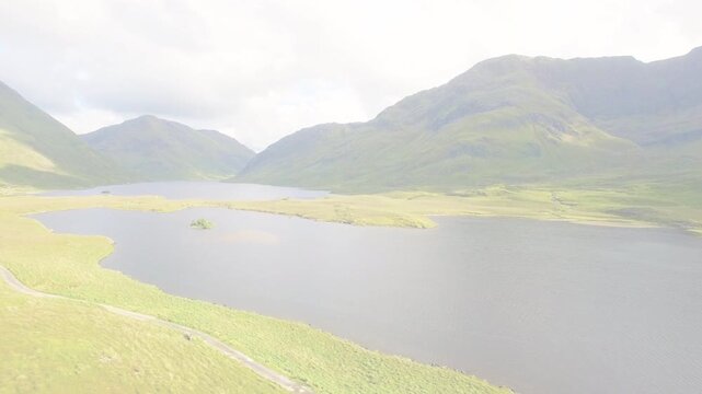 Drone drifting over lake, dashed artifact appearing, exposure shifting to reveal island