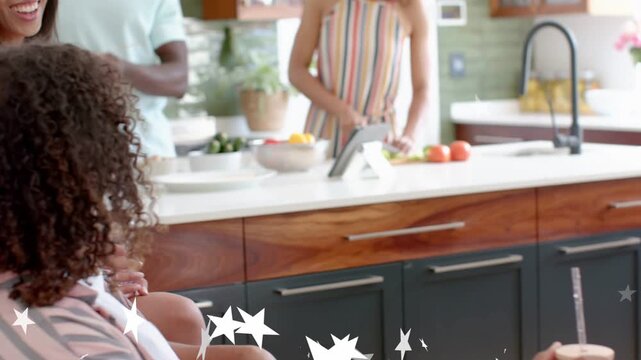 Man sipping mason jar, camera pulling back revealing cooking, stars obscuring lower frame