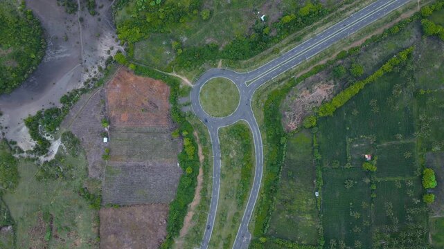 New Roundabout View. Greenbelt Roundabout With Surrounding Fields. Freshly Constructed Roundabout Amid Cleared Plots And Lanes. Aerial Perspective Of Recently Built Roundabout In Lush Green Areas