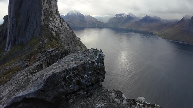 Stunning panoramic view from a cliff's edge overlooking the majestic Segla Mountain and a fjord