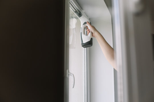Man washing and cleaning window at home. Housework and housekeeping, home hygiene
