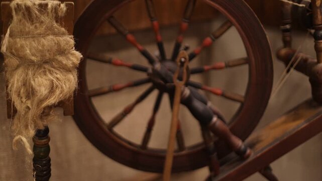 A traditional spinning wheel with a piece of jute, suitable for historical or rustic-themed images