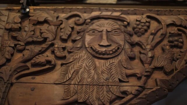 A traditional wooden sculpture of a man with a long beard, suitable for use in designs related to history, culture or fantasy