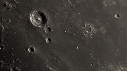 A photo of the lunar surface through an amateur telescope. The lunar surface is pockmarked with craters. © Sergei