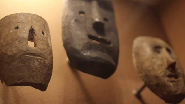 A collection of masks adorns the wall in this compact scene