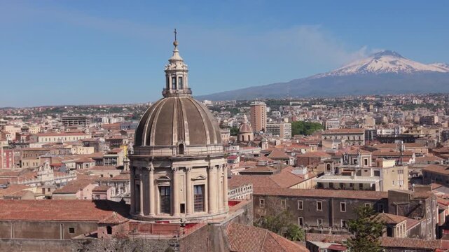flying clockwise around Cathedral domes in Catania with Mt. Etna in BG