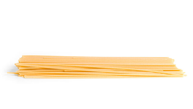 Raw bucatini pasta isolated on a white background.