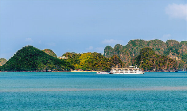 A view of a  boat mooted in front of Karst limestone islets in Ha Long Bay, Vietnam in the morning