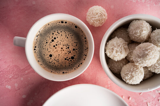 Coconut candies with nuts on pink background. Raffaello