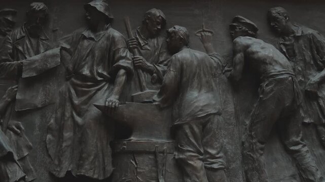 Russia. St. Petersburg, August 8, 2020 A group of people gathered around a statue of a hammer, suitable for use in editorial or conceptual contexts