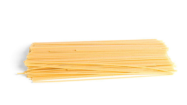 Raw bucatini pasta isolated on a white background.