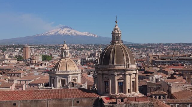 rising past Cathedral domes in Catania with Mt. Etna in BG