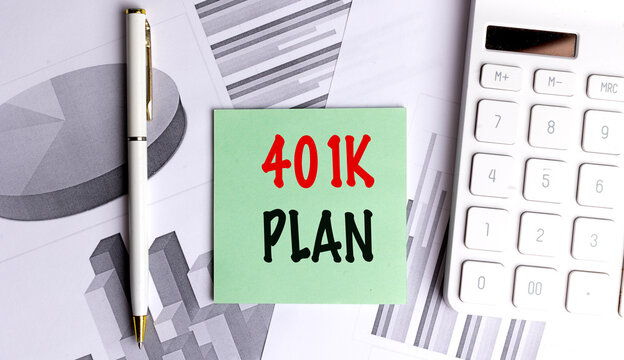 401k plan concept with sticky note calculator pen and financial charts on desk retirement savings and investment