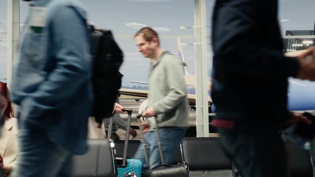 Upset woman in airport scolding man after bumping trolley into her while hurrying to catch plane. Angry tourist yelling at traveler for bashing her luggage in busy departure terminal, camera A
