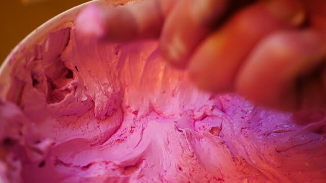 A Contractor Dabs his finger with Pink Spackle