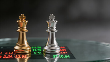 Obraz premium Gold and silver chess kings on financial index displaying market data