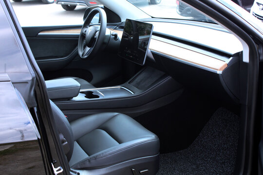 Vinnytsia, Ukraine; May 2, 2026. Black Tesla Y driver and passenger seat with steering wheel. Electric car Tesla Y dashboard. Premium electric car Tesla Y black leather interior.