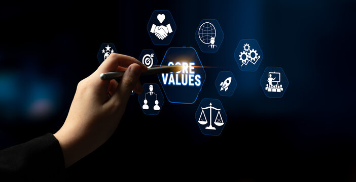Hand Holding Pen Pointing at Core Values Icons on a Digital Screen Representing Business Principles and Ethical Standards in Corporate Environment Fluxor.