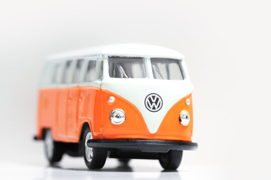 Volkswagen Type 2 miniature van toy on white background.