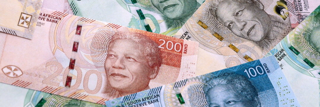 South African rand money bills pile on table. South Africa banknotes of ZAR currency close up.